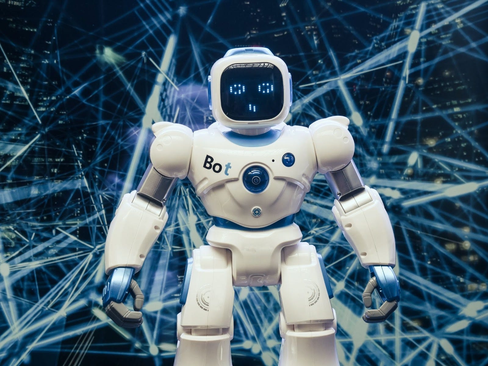 Humanoid robot standing before a glowing network of connected lines