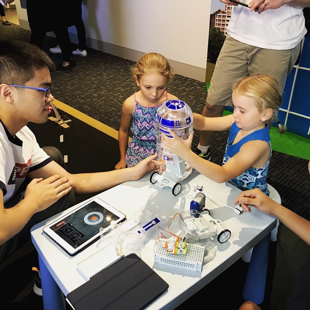 Little kids building the R2-D2 robot before launching it for its mission!