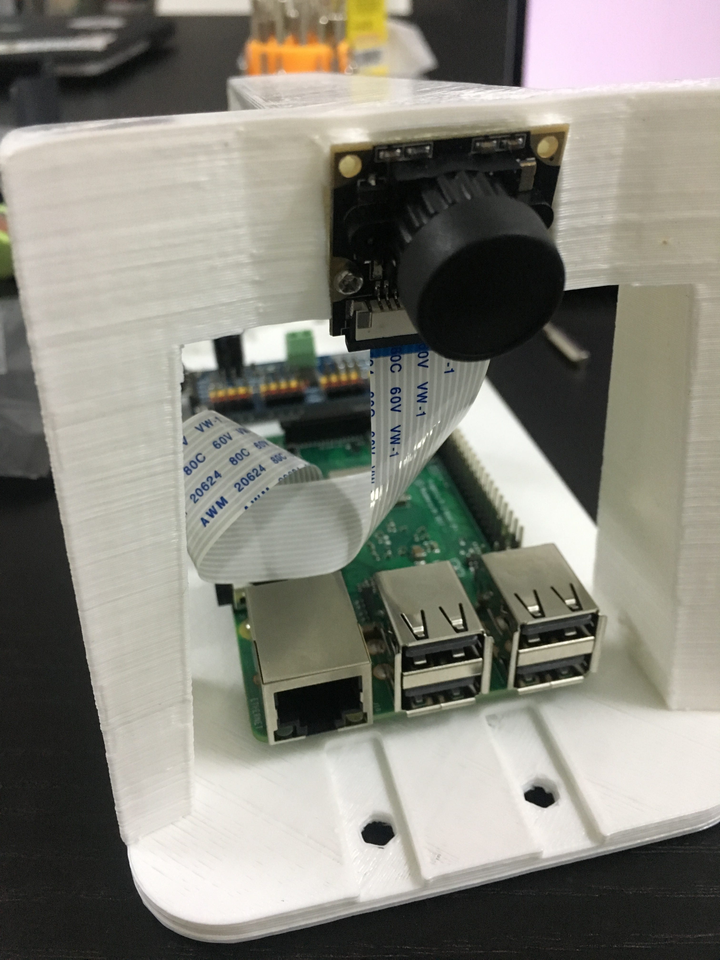 Wide-angle camera and ribbon cable mounted on the DonkeyCar chassis