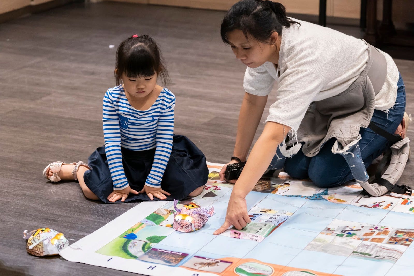 Parents and kids helping Bee-Bot find its way around the map.