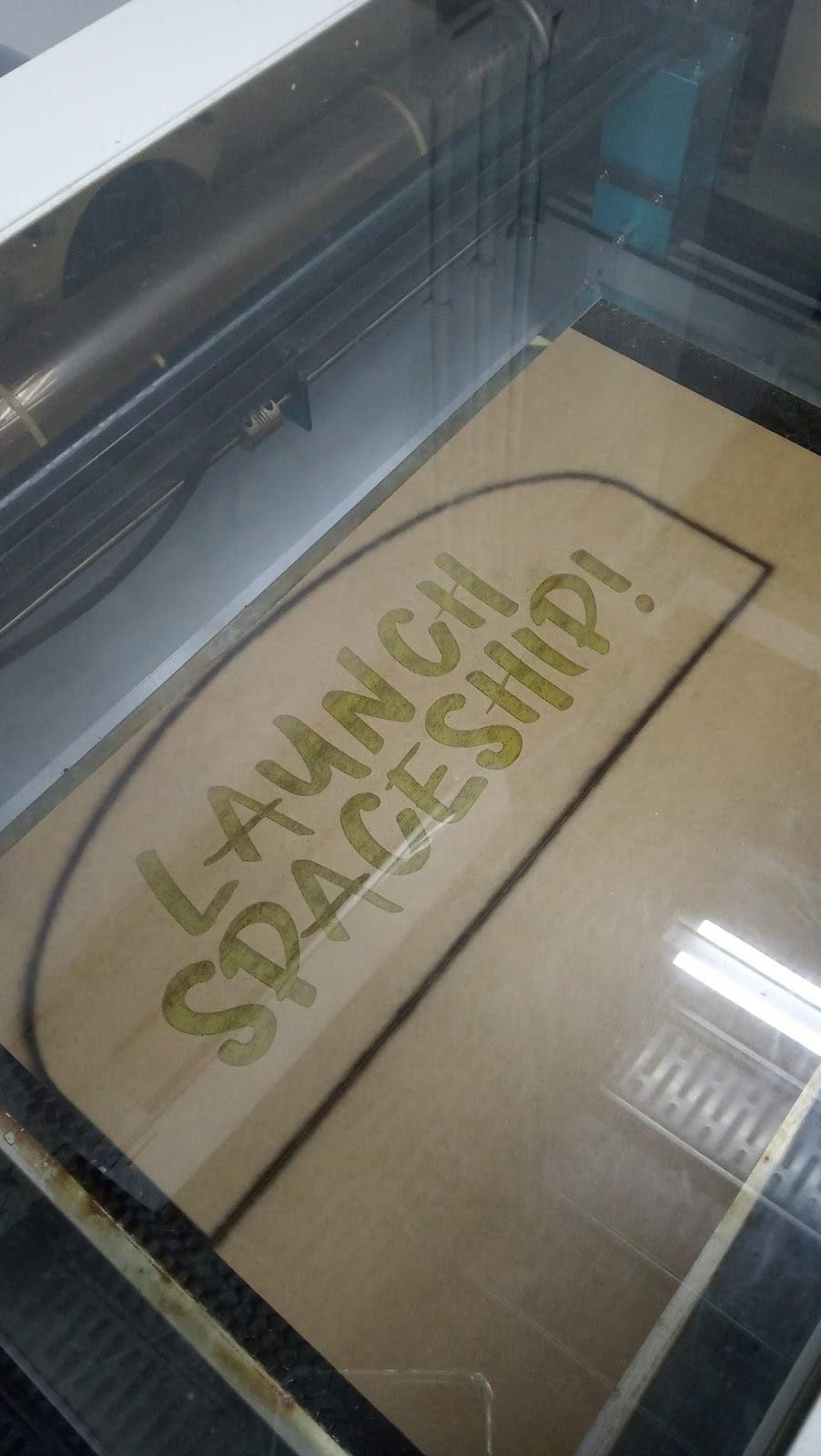 The laser charred the protective layer of paper on the piece of acrylic, but didn’t cut through fully.