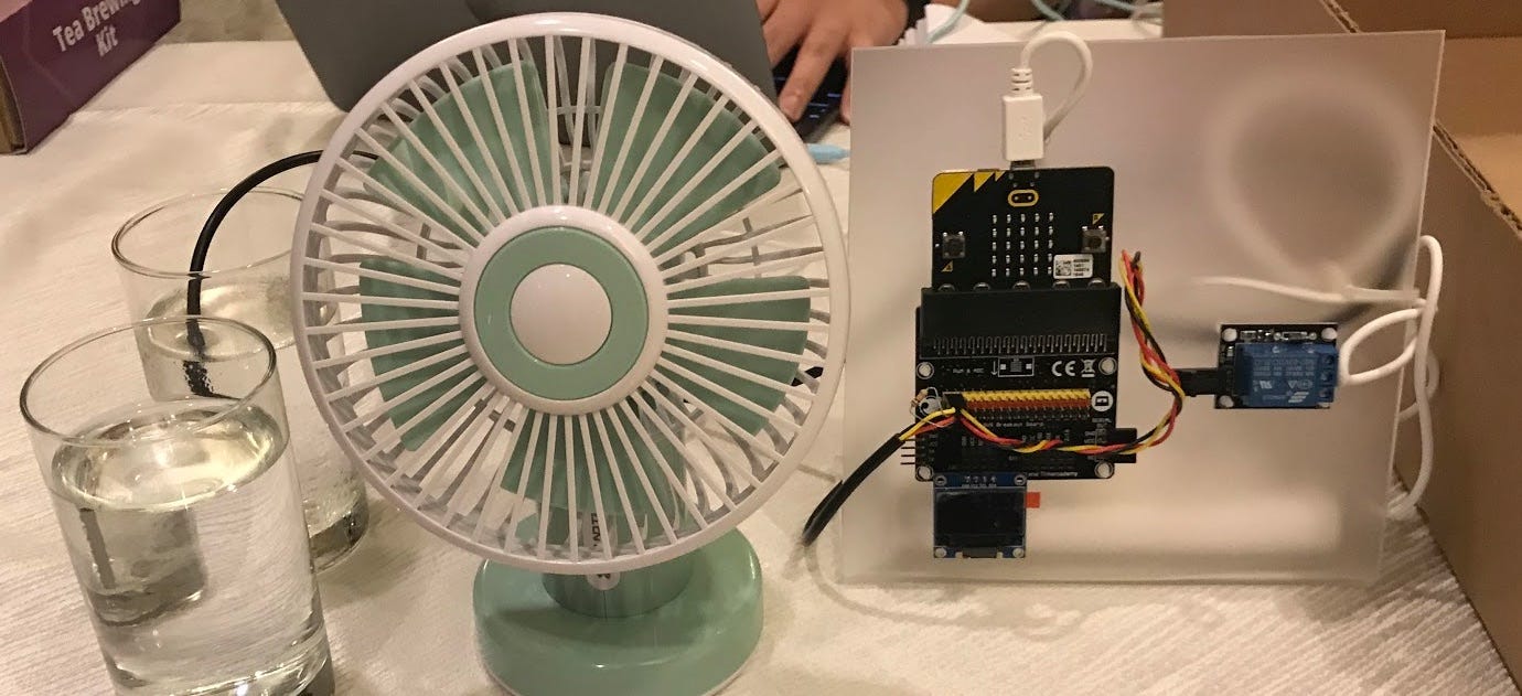The micro:bit with Breakout Board and a… fan you control using two glasses of water, maybe? We dunno ¯\_(ツ)_/¯