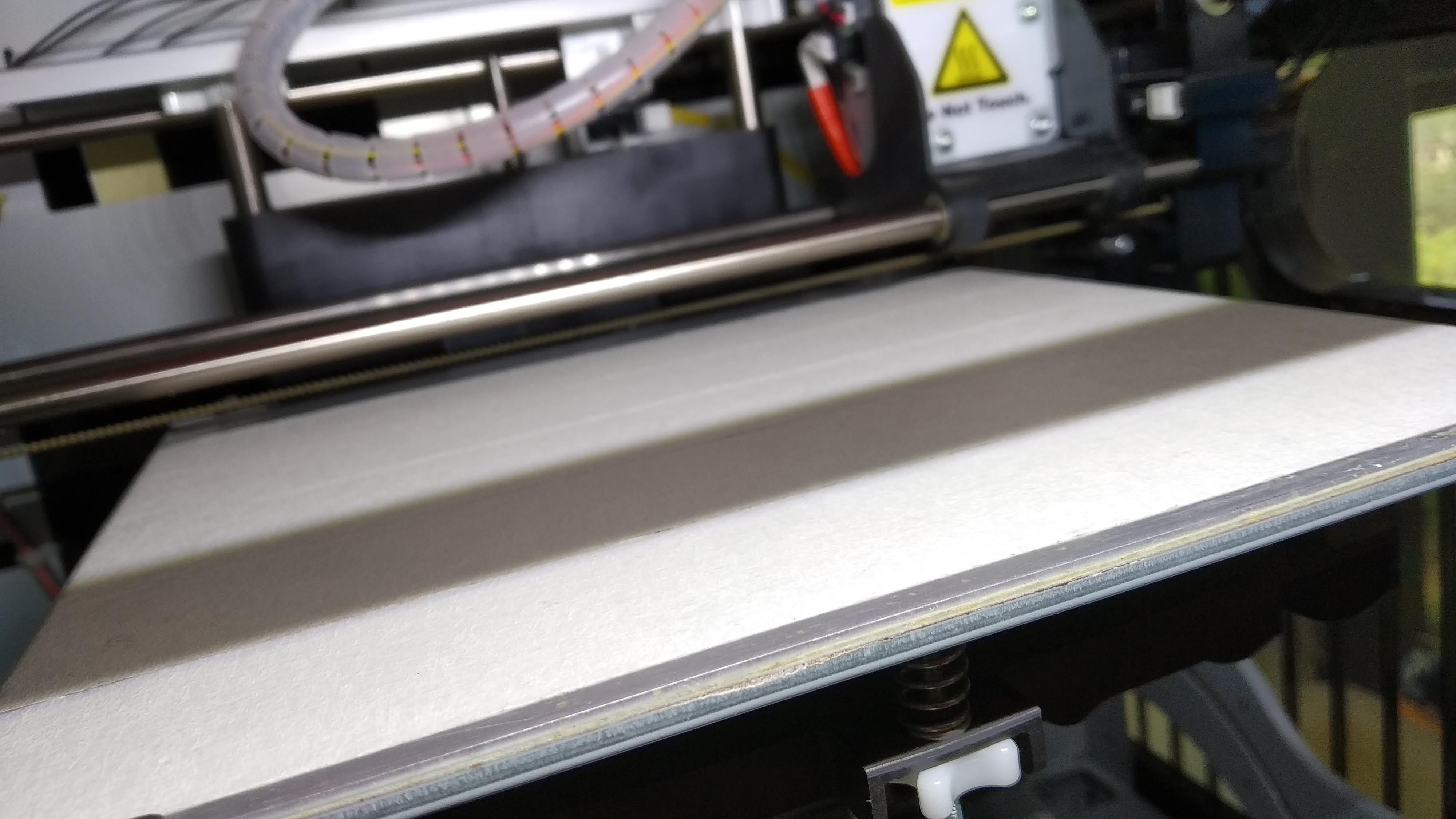 The da Vinci 1.0 Pro print bed covered with masking tape (as a cheap alternative for the adhesion sticker)