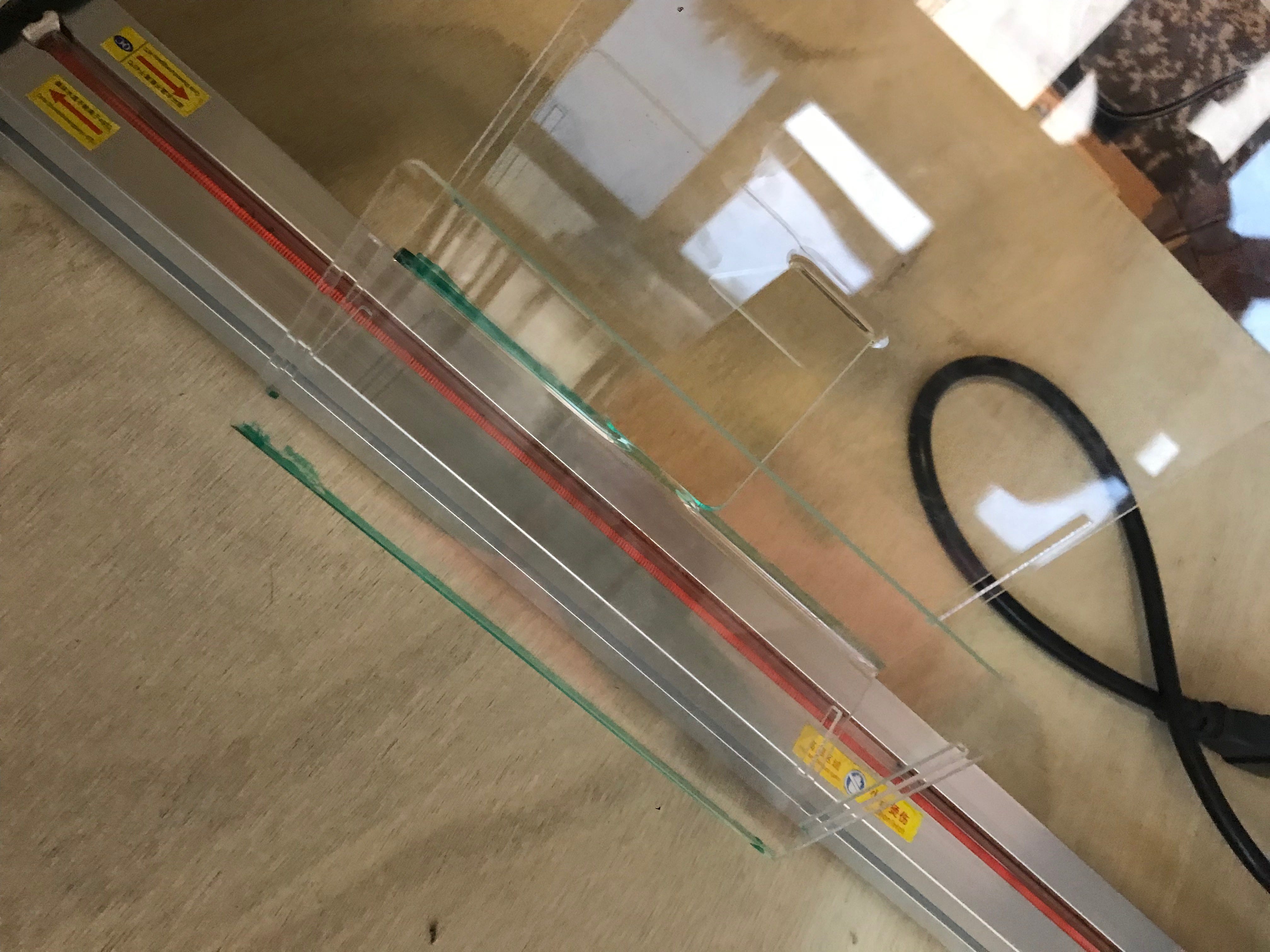 I forgot to take a picture while bending the micro:bit stand, so here’s a picture of me bending another piece of acrylic for a leaflet stand! I used green whiteboard marker to mark out the lines I wanted to bend.