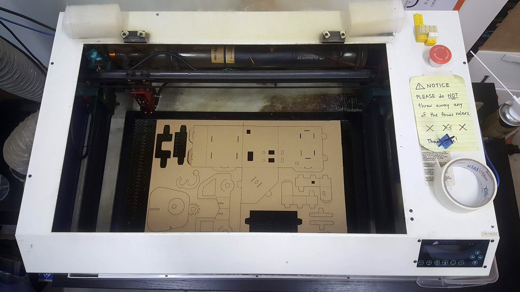 Automata parts being cut from cardboard in a laser cutter
