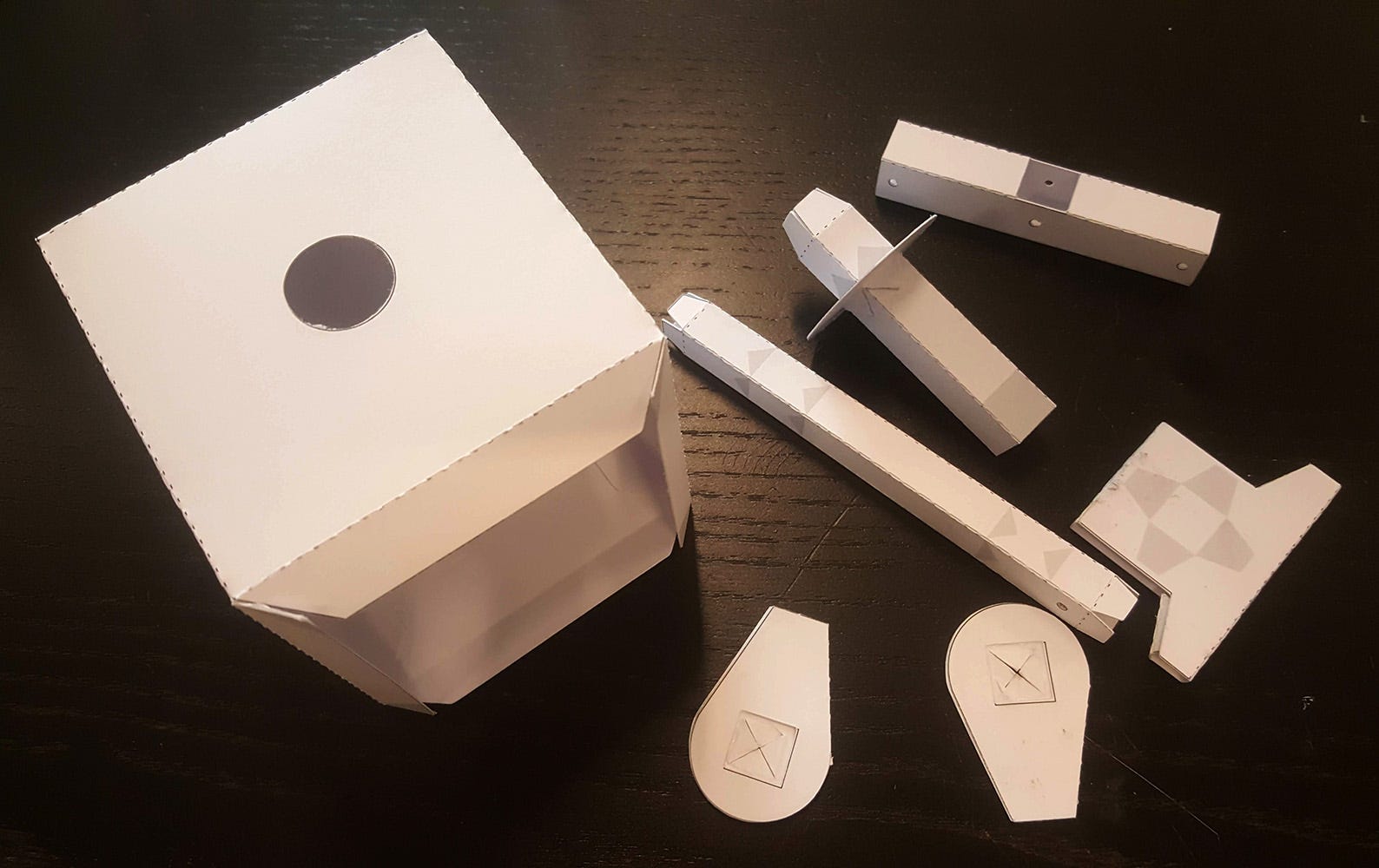 Cut paper automata parts laid out before assembly